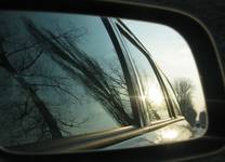 Objects in the rear view mirror may appear closer than they are.