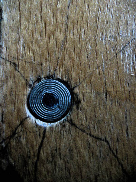 Blue metal eye in wooden chair...