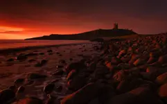 Dunstanburgh on fire